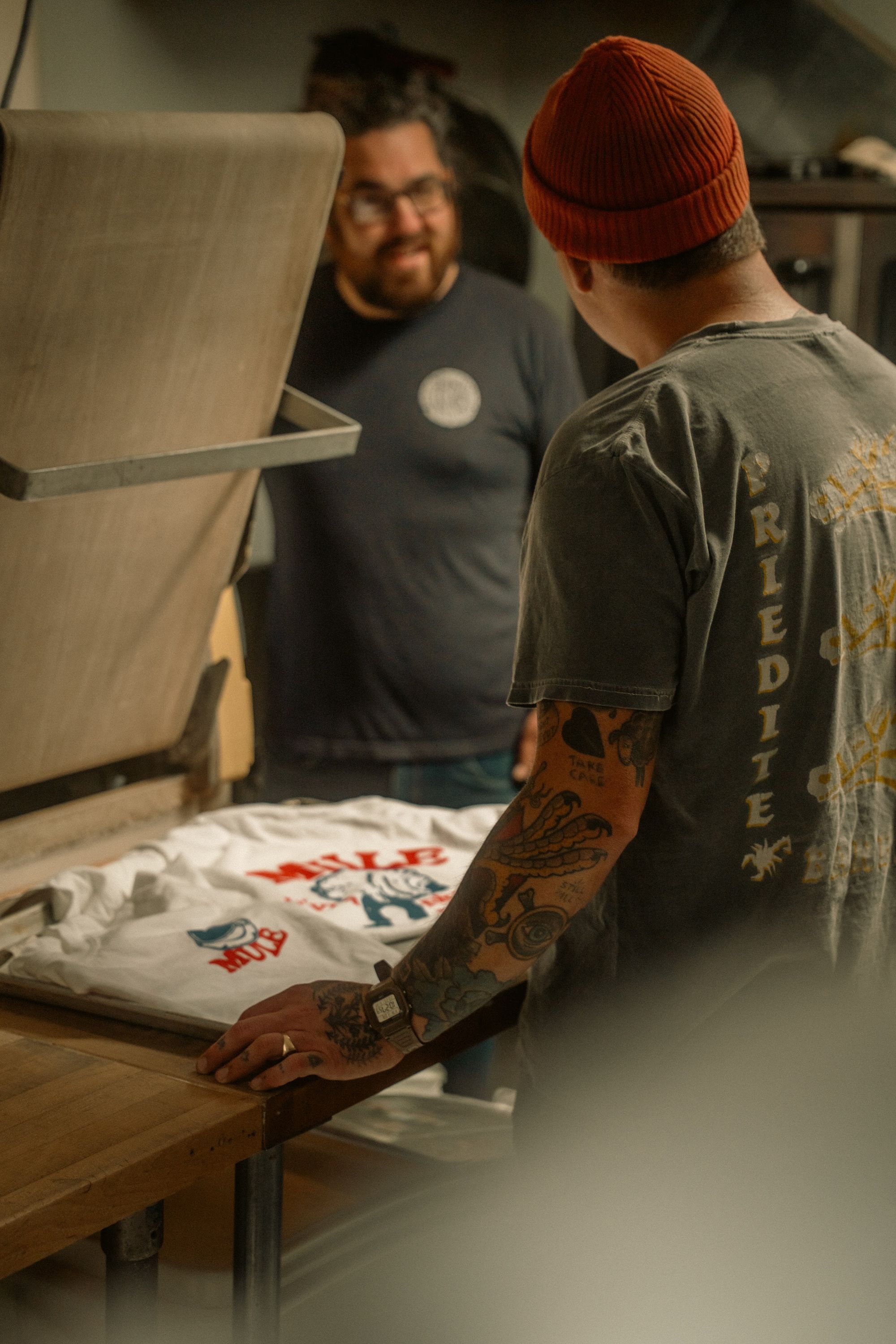 Local print shop team reviewing branded apparel production