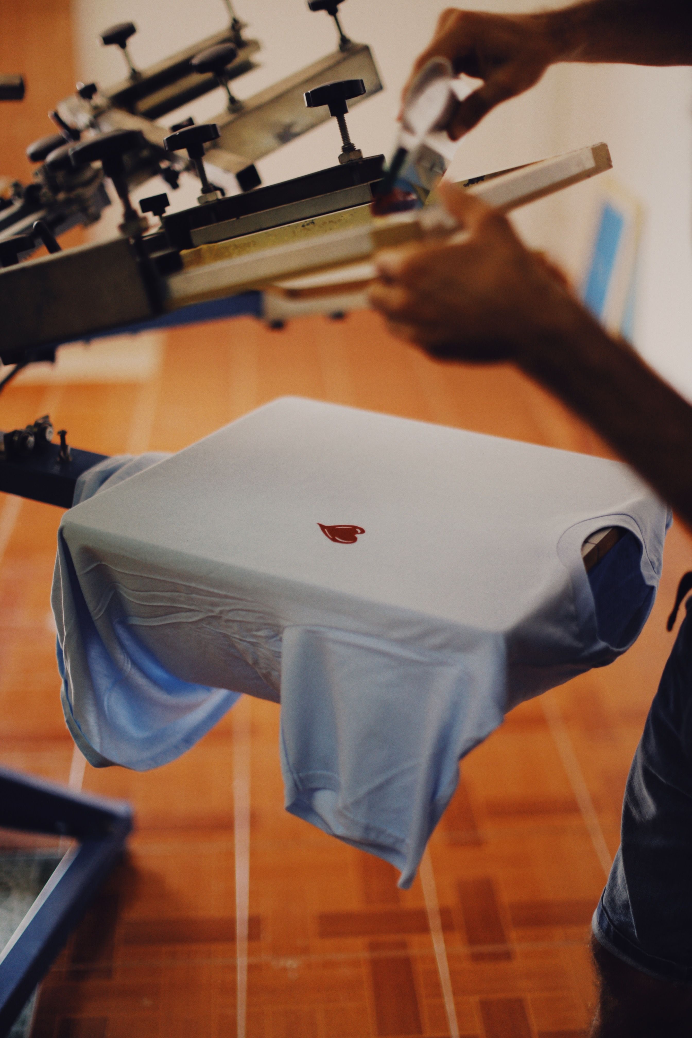 Close-up of a screen-printing production setup for custom apparel